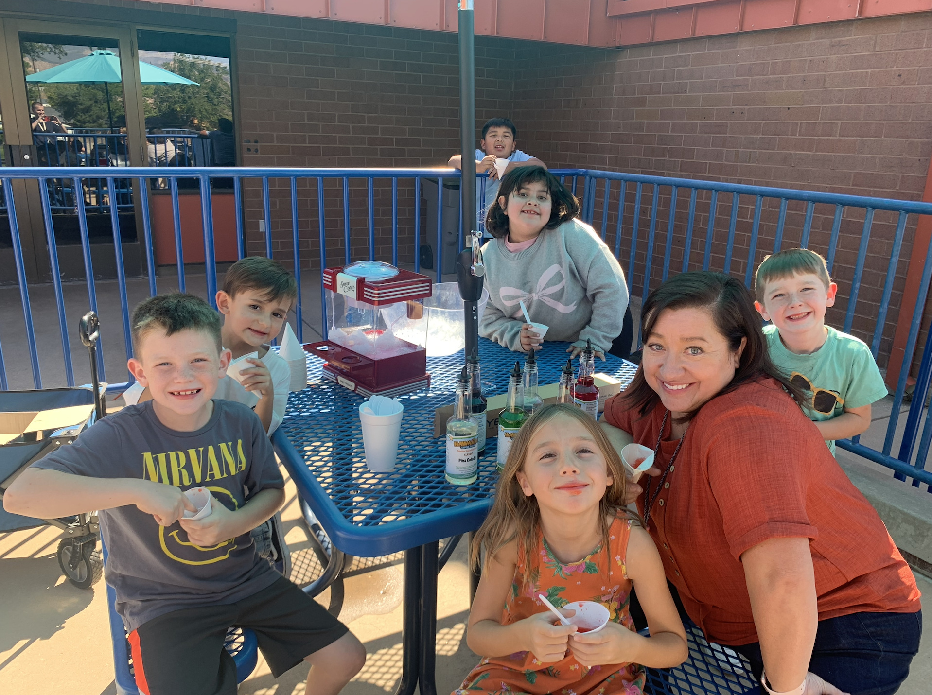 Mrs. McCaul and some of her students enjoying snow cones outside the front entrance